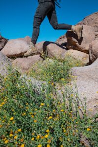 a man with a backpack is running on rocks